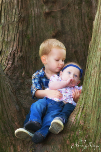 Boy and baby in tree