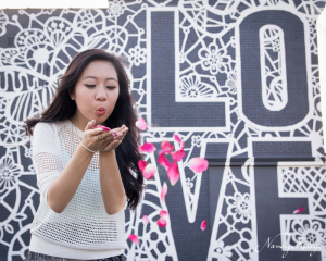 Senior blowing rose petals with love mural