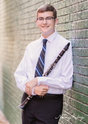 Senior in blue tie with clarinet