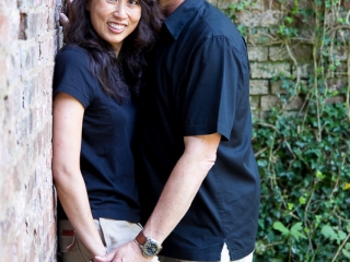 Engagement couple against ivy and brick