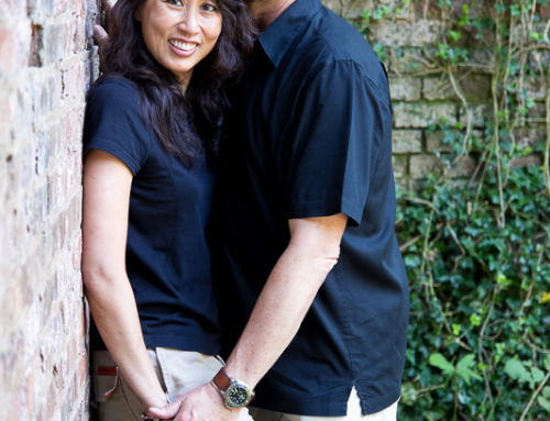 Engagement couple against ivy and brick