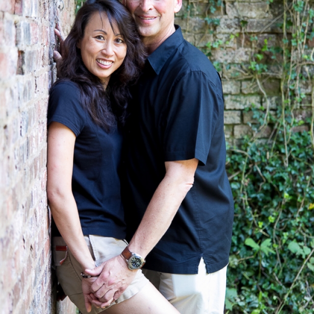 Engagement couple against ivy and brick