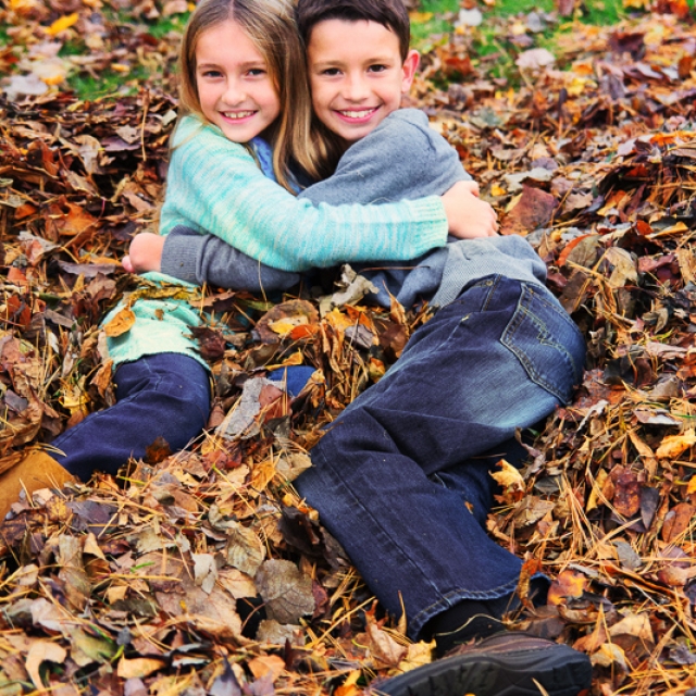 Kids hugging in leaves
