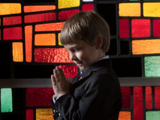 First Communion Andrew praying in window