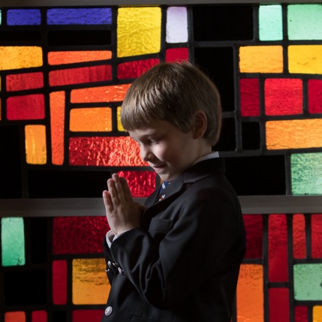 First Communion Andrew praying in window