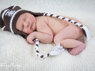 newborn in football hat