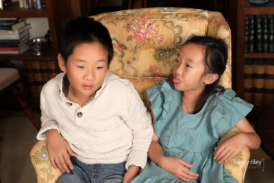 Portrait of boy and girl in chair