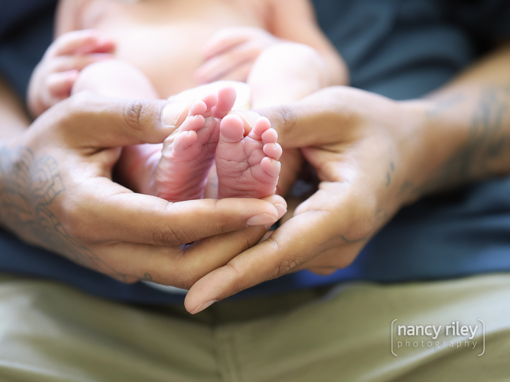 Newborn feet in father’s hands Newborn feet in father's hands