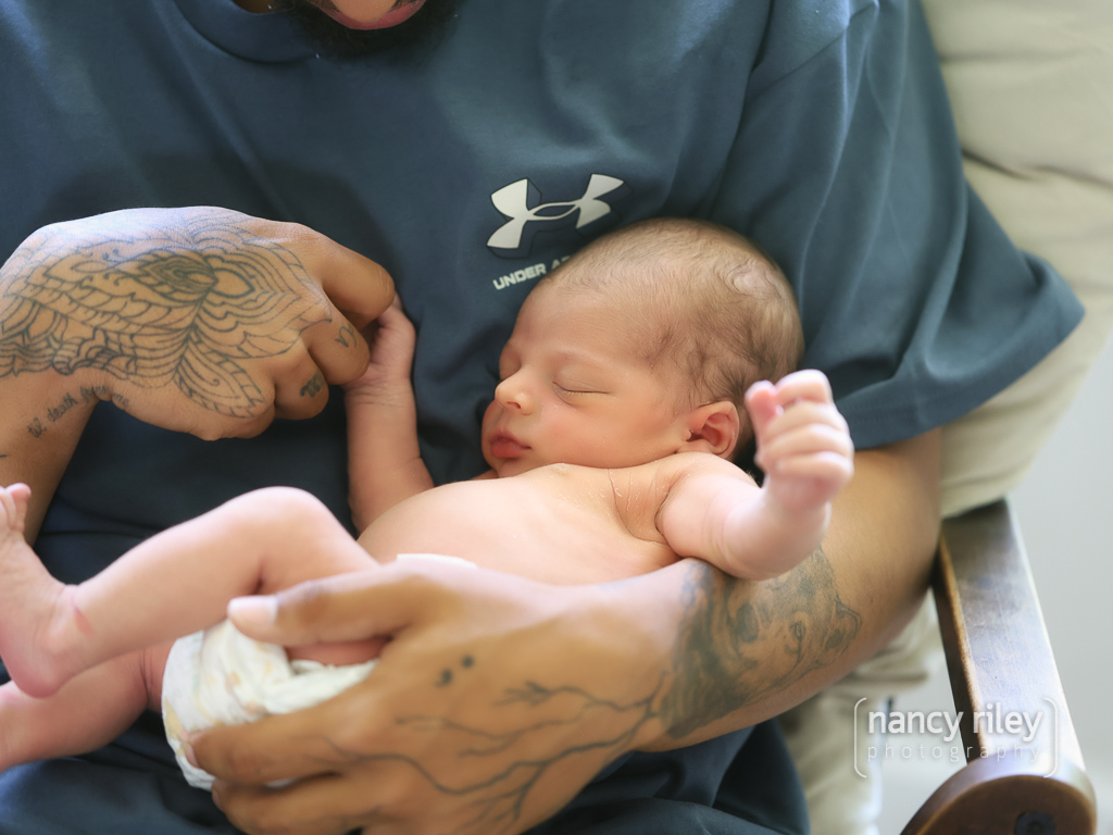 Newborn in father’s arms Newborn in father's arms