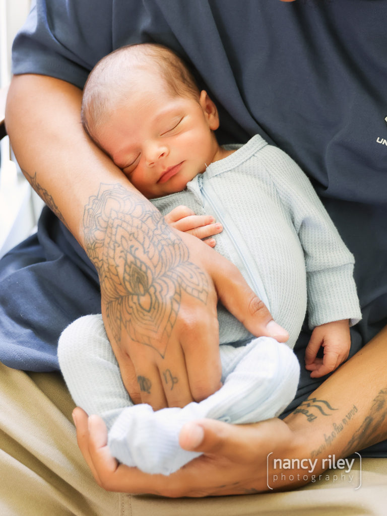 Newborn in father’s arms Newborn in father's arms