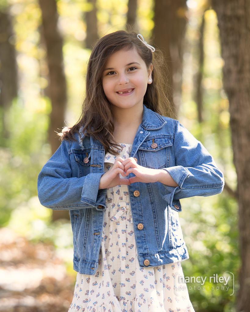 Young girl making heart hands Young girl making heart hands