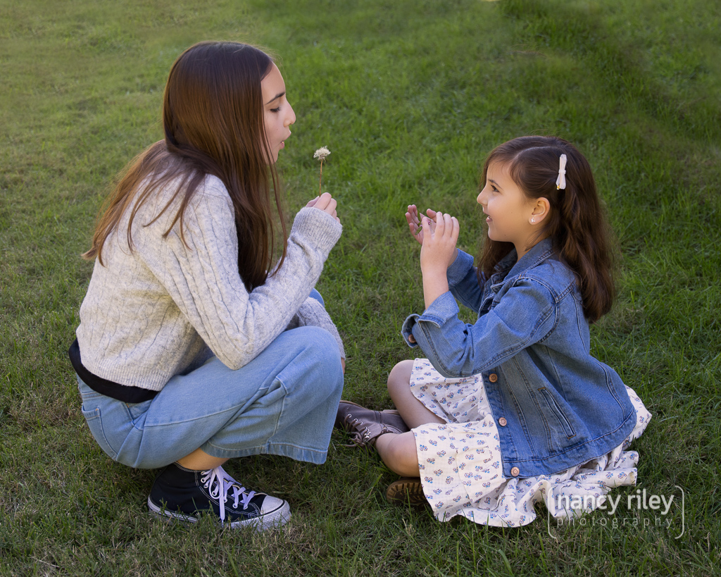 Girls blowing dandelions Girls blowing dandelions
